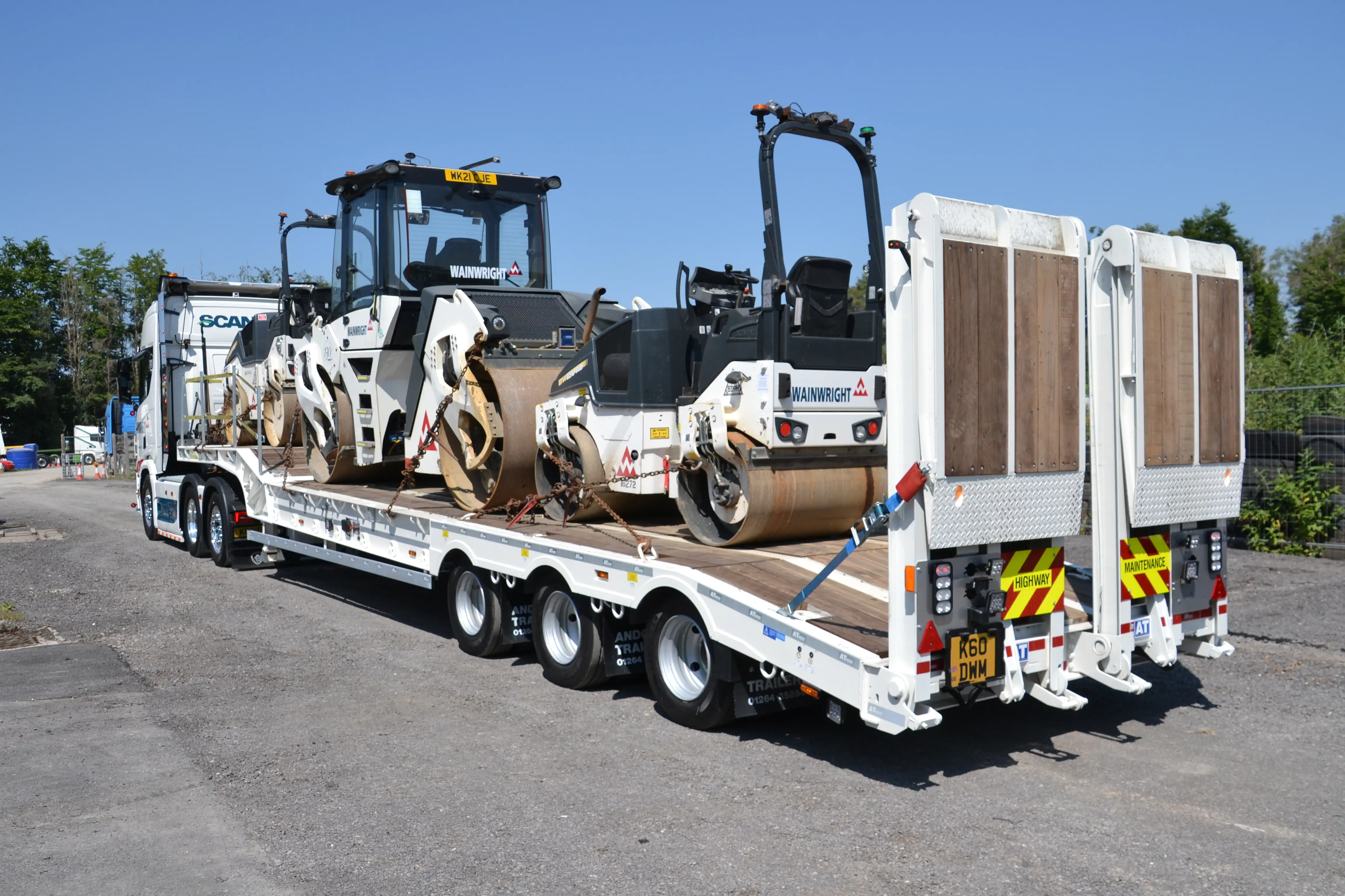 Sloping deck trailer loaded.